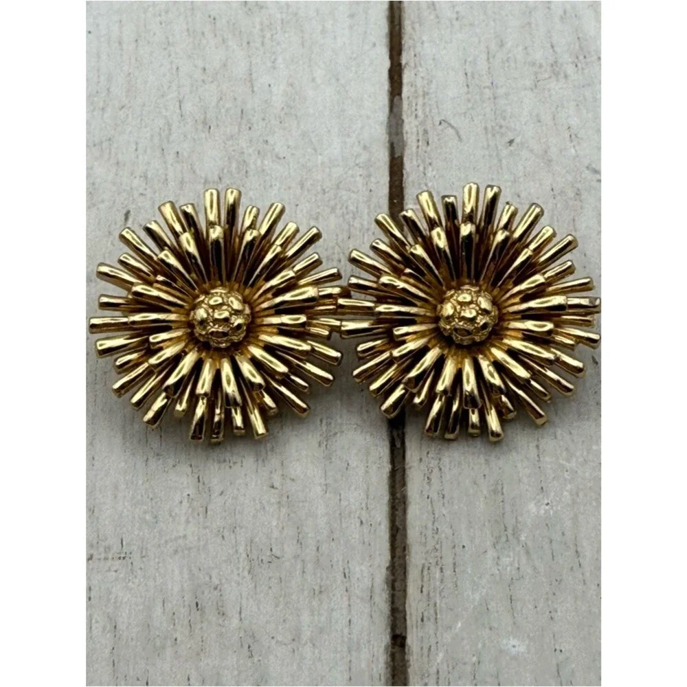 Vintage Monet gold tone starburst flower clip on earrings